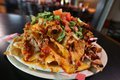 rsz_thumbnail_the_halligan_barpct27s_nachos_-_layers_and_layers_of_smoked_meatpct2c_gooey_cheesepct2c_and_spi-1.jpg