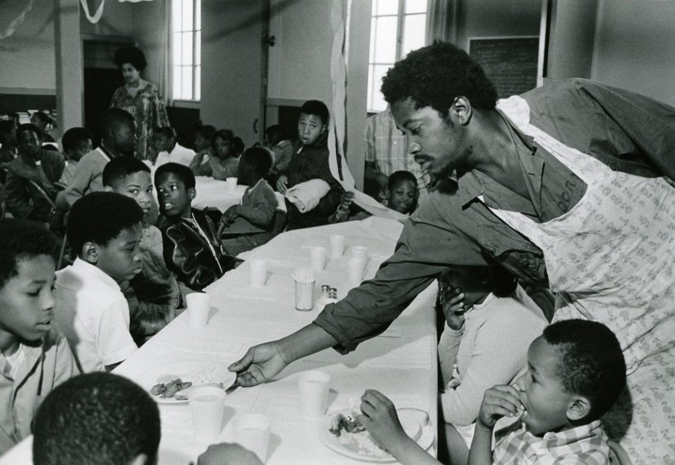 #2 Charles Bursey hands plate of food to a child seated at Free Breakfast Program.  Photo courtesy of Pirkle Jones and Ruth-Marion Baruch.PJ_v1CROPPED.jpg