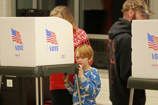 Sarah Graves votes, while her son Hudson,7, waitsJPG.JPG