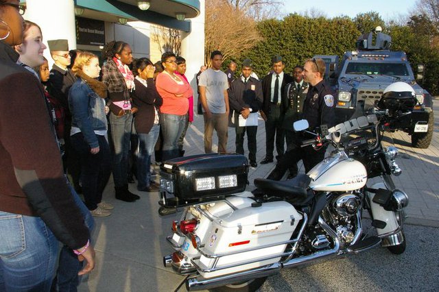 Students view RPD motorcycle, armored vehicle.jpg